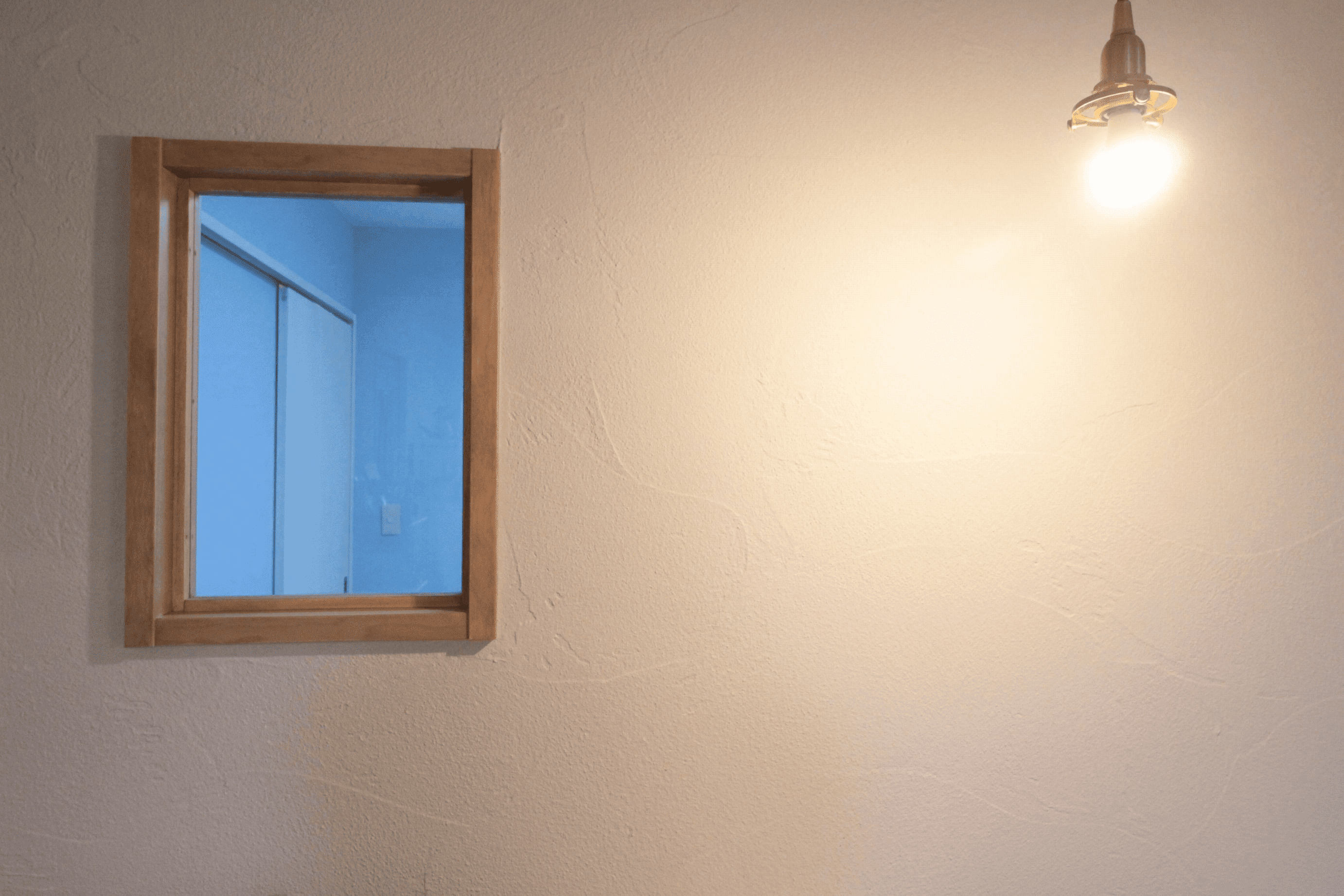 照明が照らす珪藻土の壁と造作内窓
